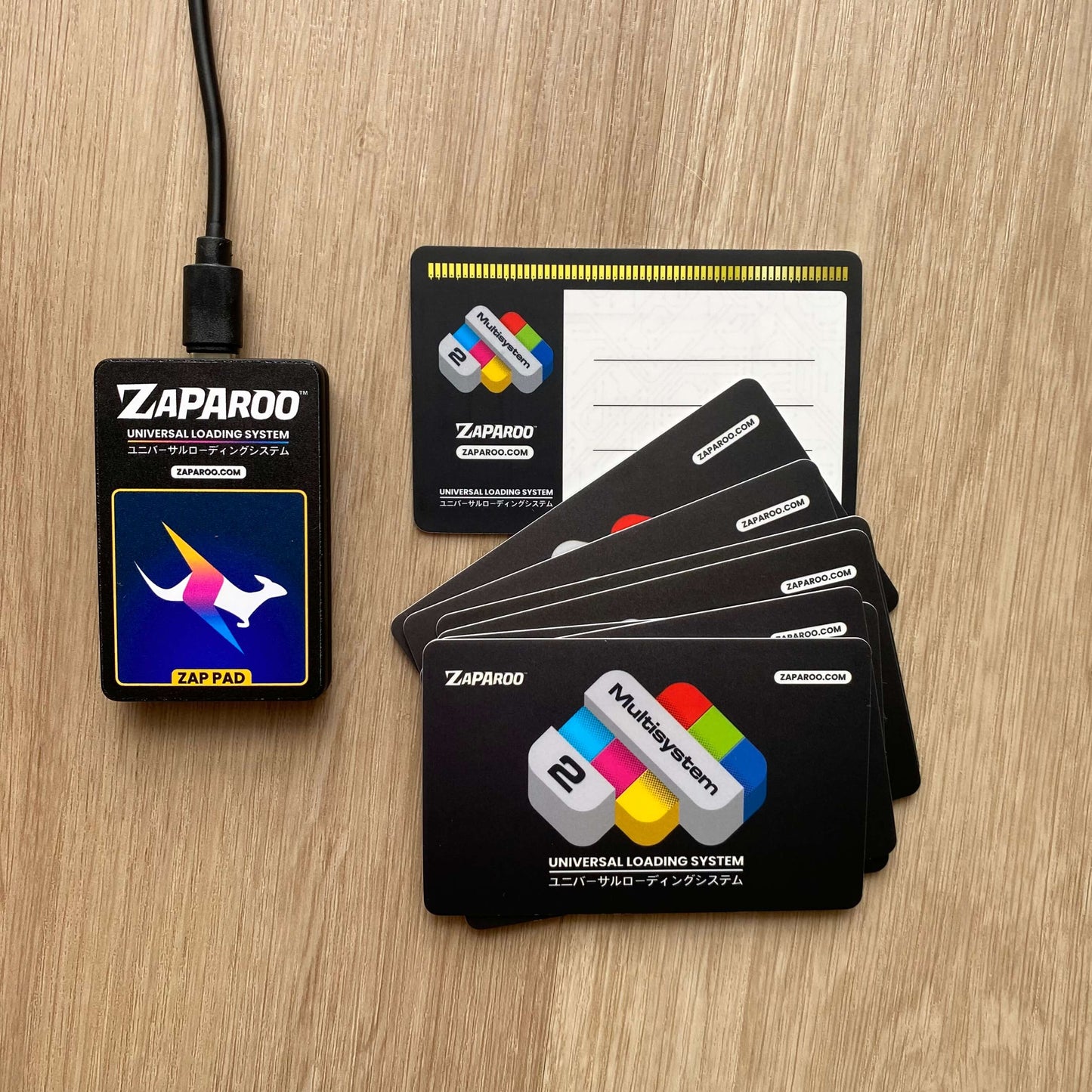Black Zap Pad NFC reader with custom Zaparoo branded cards